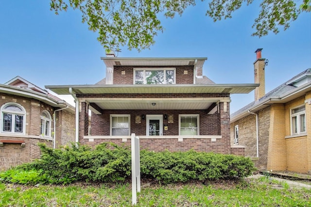 view of front of home with covered porch and brick siding