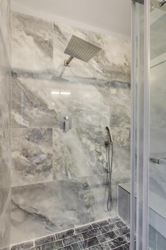 bathroom with a marble finish shower