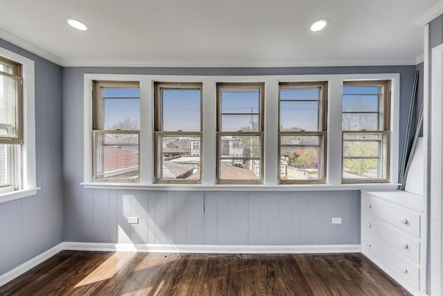 spare room with baseboards, dark wood-type flooring, crown molding, and recessed lighting