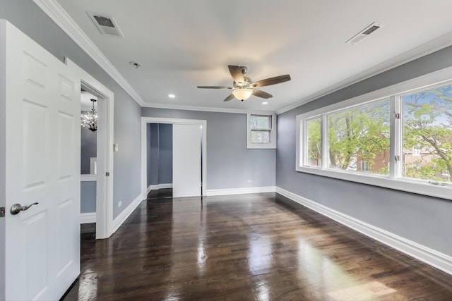 unfurnished room with ornamental molding, baseboards, ceiling fan, wood finished floors, and a chandelier