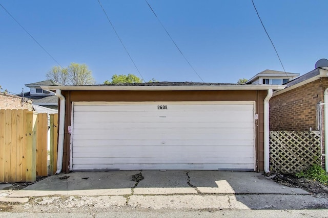 detached garage featuring fence
