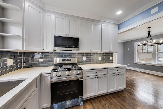 kitchen with appliances with stainless steel finishes, open shelves, ornamental molding, dark wood-style flooring, and baseboards