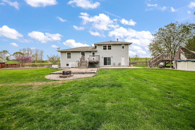 back of house with a deck, fence, a patio, a fire pit, and stairs