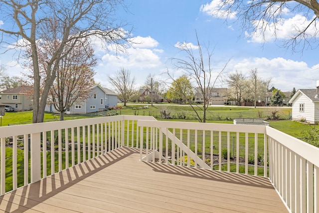 wooden terrace with a yard and a residential view