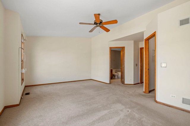 empty room with baseboards, a ceiling fan, light colored carpet, and visible vents