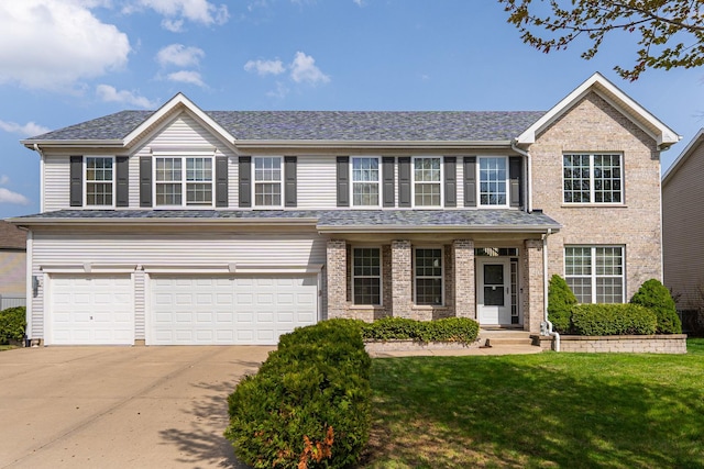 405 Blue Heron Cir, Bartlett, IL 60103 - traditional home with an attached garage, brick siding, a front yard, and concrete driveway