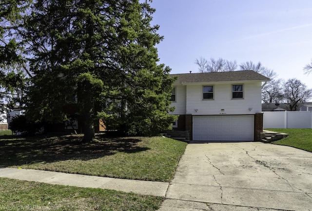 view of front facade featuring fence, an attached garage, brick siding, a front yard, and concrete driveway
