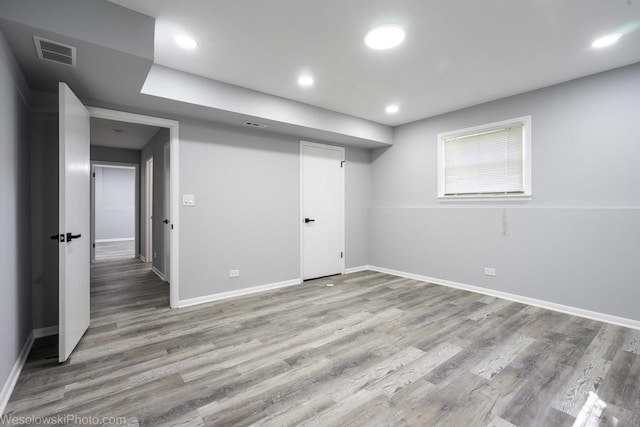 basement featuring visible vents, recessed lighting, baseboards, and wood finished floors