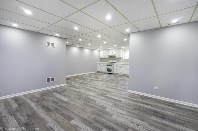 unfurnished living room featuring baseboards, recessed lighting, wood finished floors, and visible vents