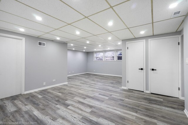 basement featuring baseboards, recessed lighting, wood finished floors, and visible vents