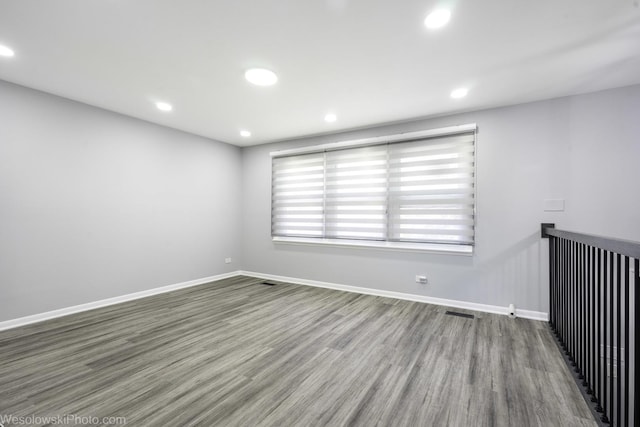 unfurnished room featuring recessed lighting, baseboards, visible vents, and wood finished floors