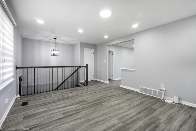 spare room with visible vents, recessed lighting, baseboards, and wood finished floors