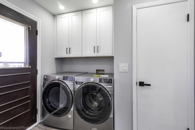 laundry area with washing machine and clothes dryer, recessed lighting, and cabinet space