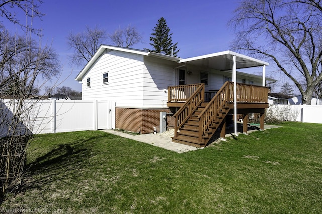 rear view of property with stairs, fence, a yard, and a wooden deck