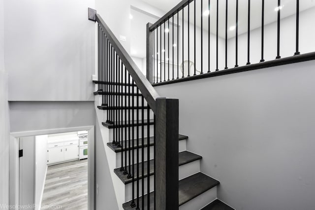 stairway with wood finished floors