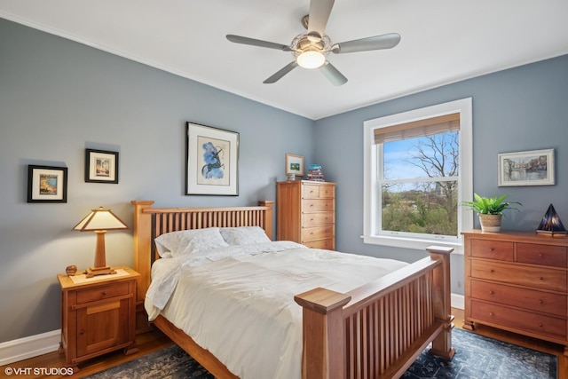 bedroom featuring baseboards, dark wood-style flooring, and ceiling fan
