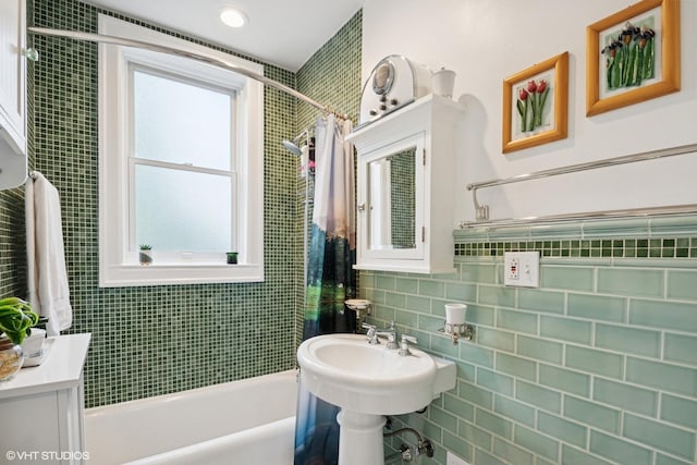 bathroom with shower / bath combo, backsplash, and tile walls