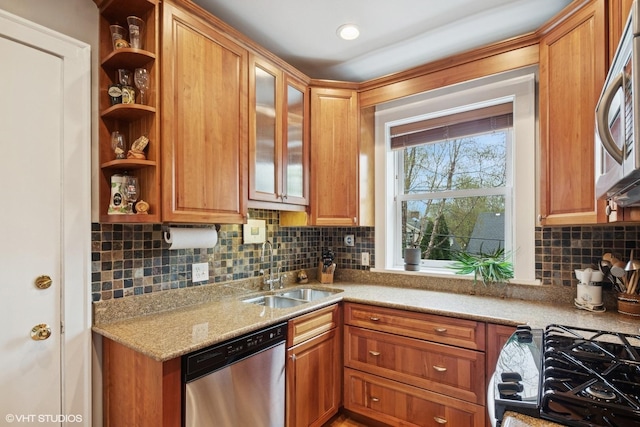 kitchen featuring appliances with stainless steel finishes, a sink, decorative backsplash, light stone countertops, and open shelves