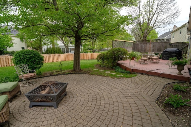 600 Salceda Dr, Mundelein, IL 60060 - fenced backyard with a fire pit, a deck, a patio, and grilling area
