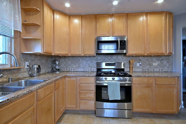 kitchen featuring stainless steel appliances, open shelves, light tile patterned floors, recessed lighting, and a sink