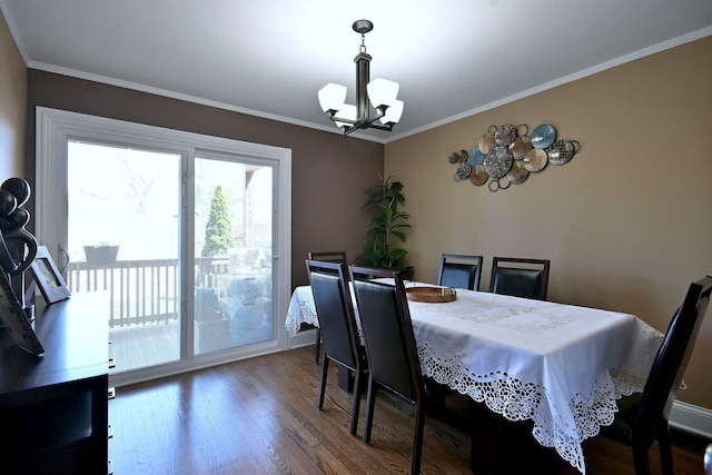 dining room with a chandelier, crown molding, and wood finished floors