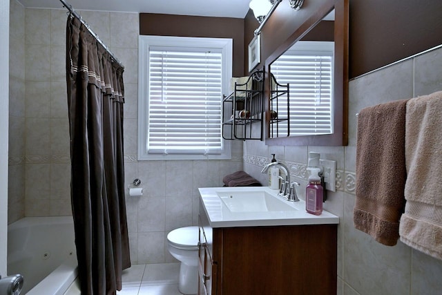 bathroom with tile walls, toilet, shower / bath combination with curtain, vanity, and healthy amount of natural light