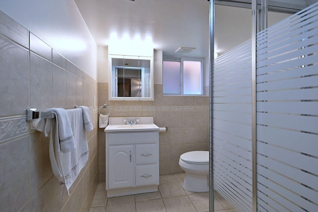 full bath featuring tile patterned floors, toilet, tile walls, and vanity