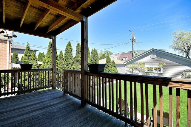 wooden terrace featuring a lawn