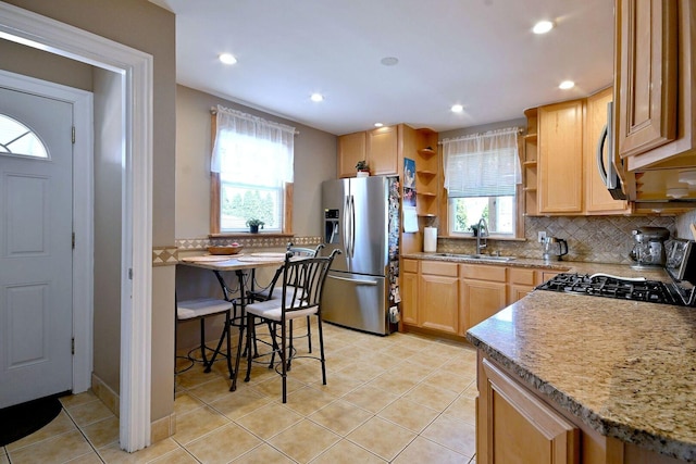 kitchen featuring appliances with stainless steel finishes, open shelves, a sink, decorative backsplash, and recessed lighting