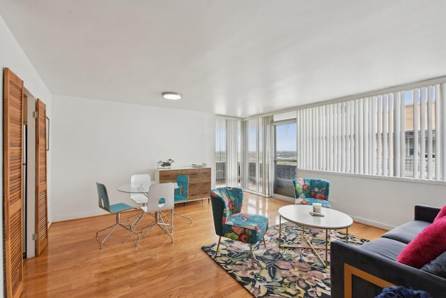living room with baseboards and light wood finished floors