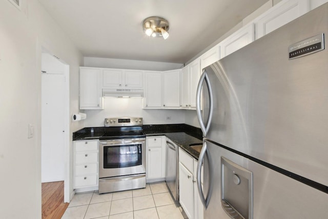 kitchen with appliances with stainless steel finishes, under cabinet range hood, white cabinets, and light tile patterned floors