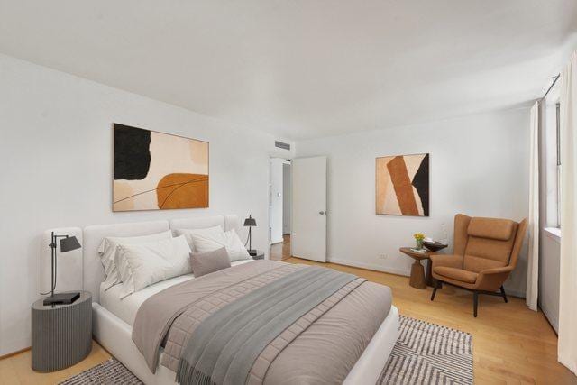 bedroom with visible vents and light wood-style floors