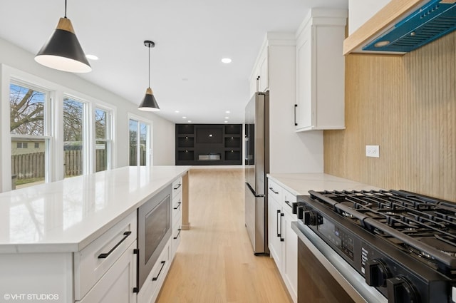 1816 W Pheasant Trl, Mount Prospect, IL 60056 - kitchen featuring white cabinets, stainless steel appliances, light wood-type flooring, wall chimney exhaust hood, and hanging light fixtures