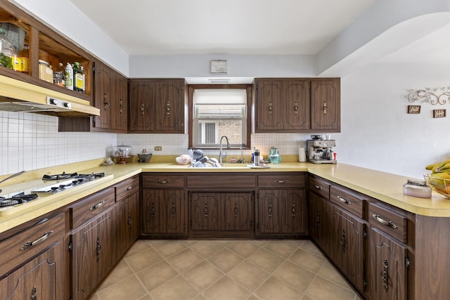 8515 S Kildare Ave, Chicago, IL 60652 - kitchen with backsplash, a sink, light countertops, a peninsula, and white gas stovetop