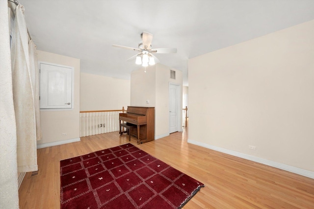 unfurnished room with ceiling fan, baseboards, wood finished floors, and visible vents