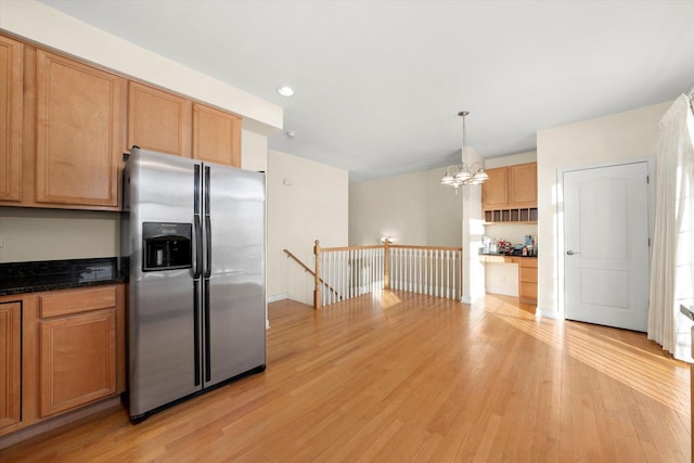 kitchen featuring recessed lighting, an inviting chandelier, stainless steel fridge, light wood-style flooring, and hanging light fixtures