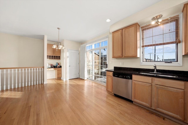 kitchen with stainless steel dishwasher, a chandelier, decorative light fixtures, a sink, and light wood-type flooring