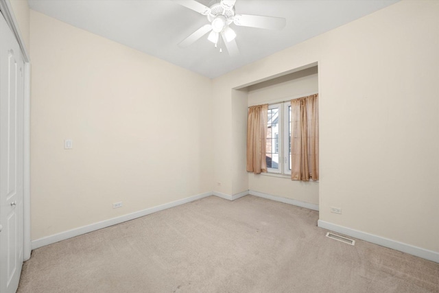 empty room featuring baseboards, visible vents, ceiling fan, and carpet flooring