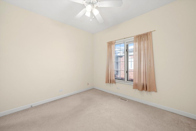 empty room with baseboards, a ceiling fan, visible vents, and light carpet