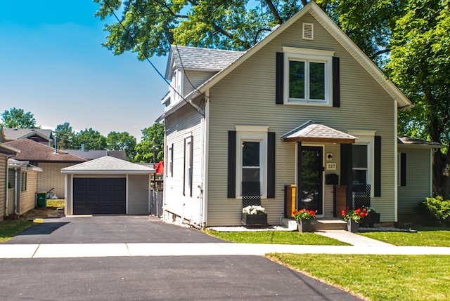 227 E 6th St, Lockport, IL 60441 - view of front of home with a garage, an outdoor structure, asphalt driveway, and a front yard