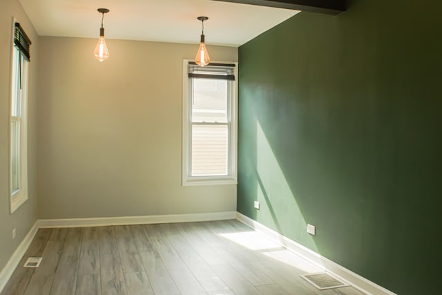 227 E 6th St, Lockport, IL 60441 - empty room featuring wood finished floors, baseboards, and healthy amount of natural light