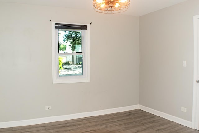 227 E 6th St, Lockport, IL 60441 - spare room with wood finished floors, baseboards, and a chandelier