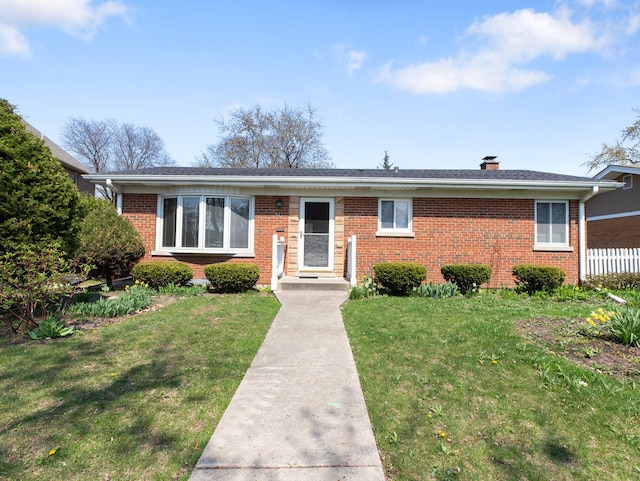 single story home featuring a front lawn, a chimney, and brick siding