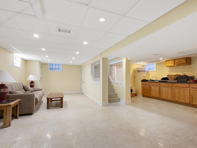 living room with baseboards, visible vents, stairway, and recessed lighting
