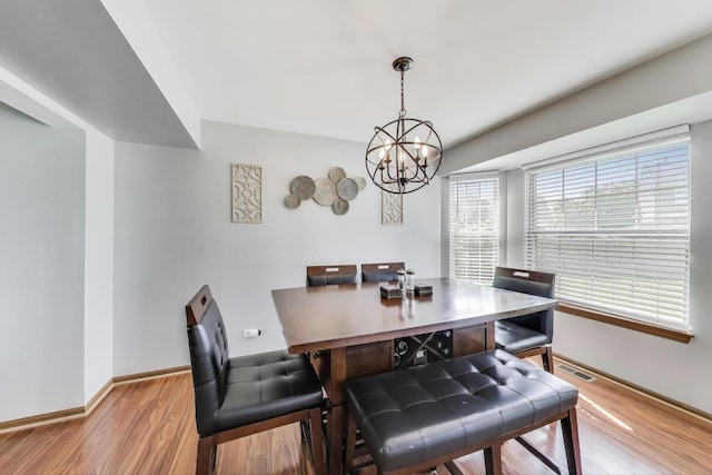 1214 Lone Oak Trl, Aurora, IL 60506 - dining area featuring wood finished floors, a chandelier, and baseboards