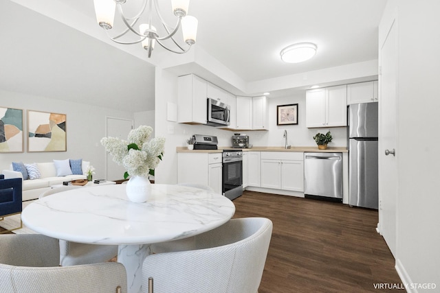 720 N Austin Blvd Unit Gnw, Oak Park, IL 60302 - kitchen featuring an inviting chandelier, white cabinets, stainless steel appliances, and dark wood-type flooring