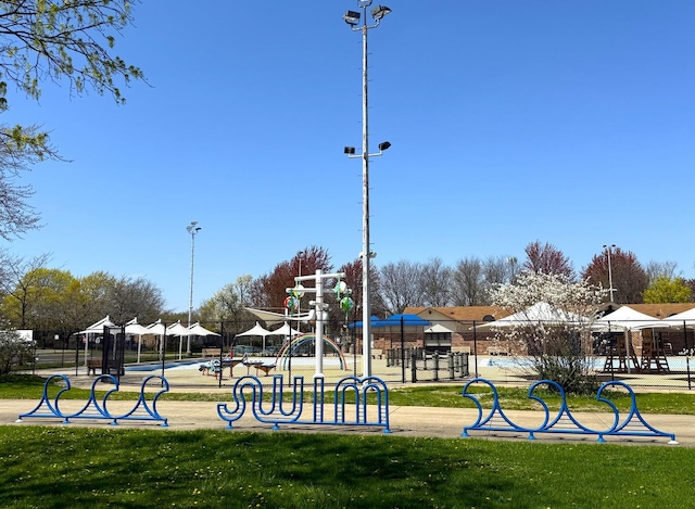 community jungle gym featuring a lawn