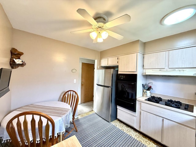 kitchen featuring under cabinet range hood, a warming drawer, light countertops, black appliances, and a ceiling fan