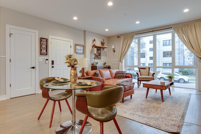 living room with recessed lighting, visible vents, and light wood-style flooring