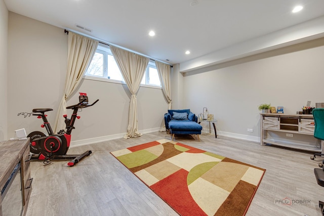 exercise area featuring baseboards, recessed lighting, wood finished floors, and visible vents